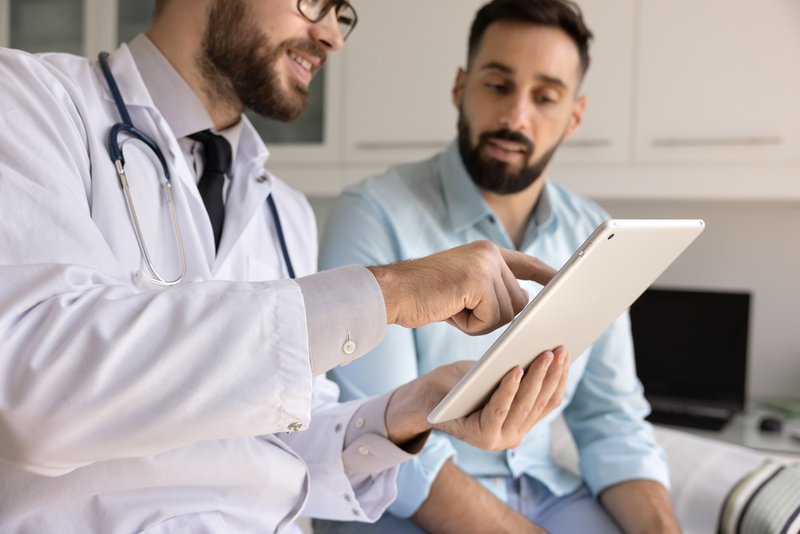 Young adult man talking to his primary care provider