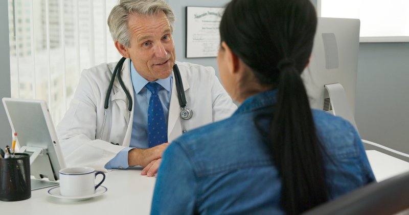 Doctor giving chronic disease management advice to patient.